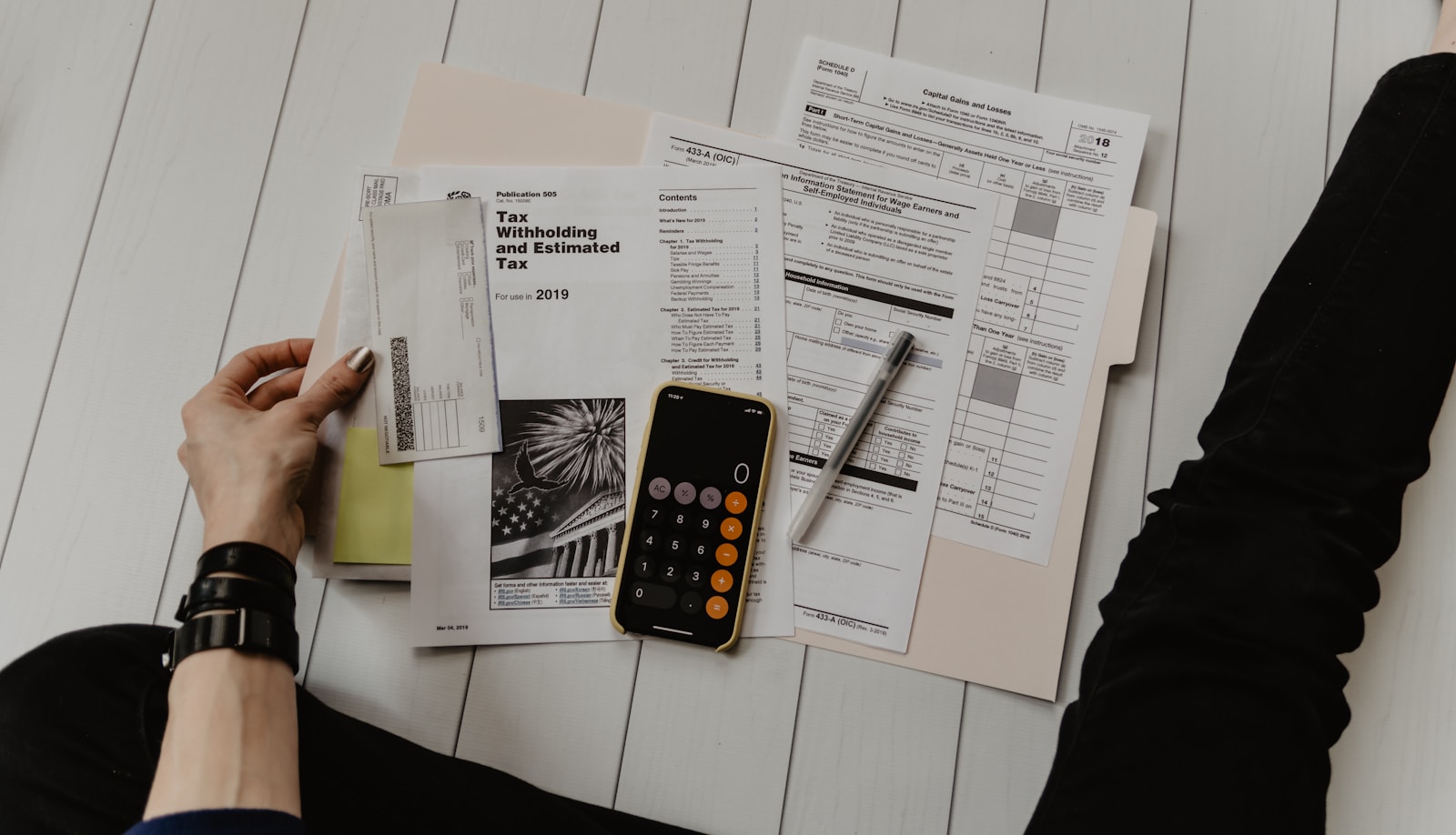 Tax documents and a calculator laid out on a desk