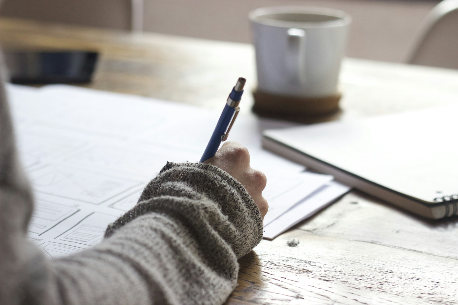 Working through coverage numbers in a notebook at a desk